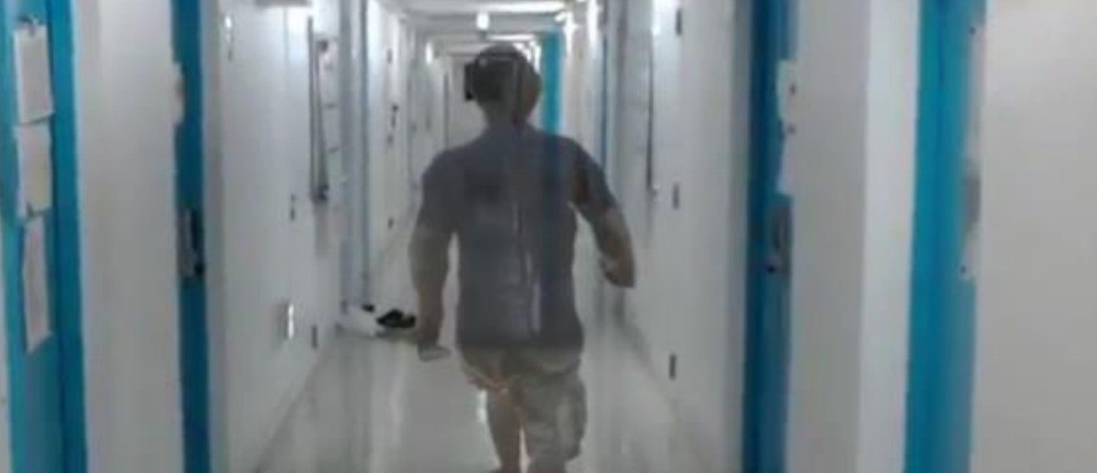 A participant walking a hallway while wearing a HoloLens