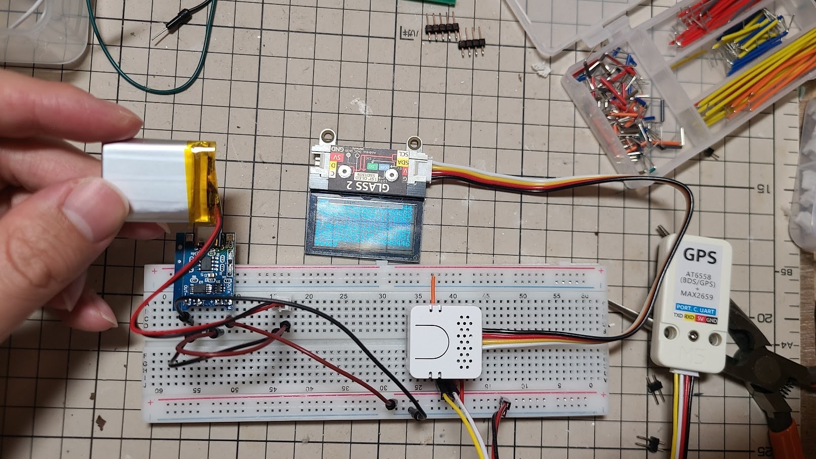 A breadboard prototype with a GPS unit on the workbench