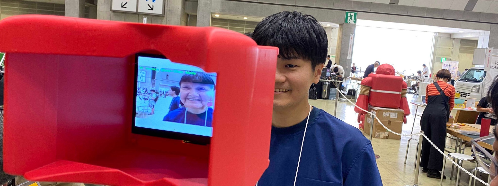 Trying RealityShiftAR at a Maker Faire booth, the headset's display showing a transformed face